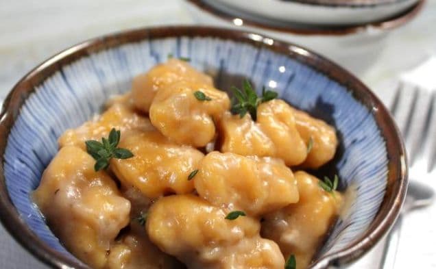 Bowl of butternut squash gnocchi with fresh thyme